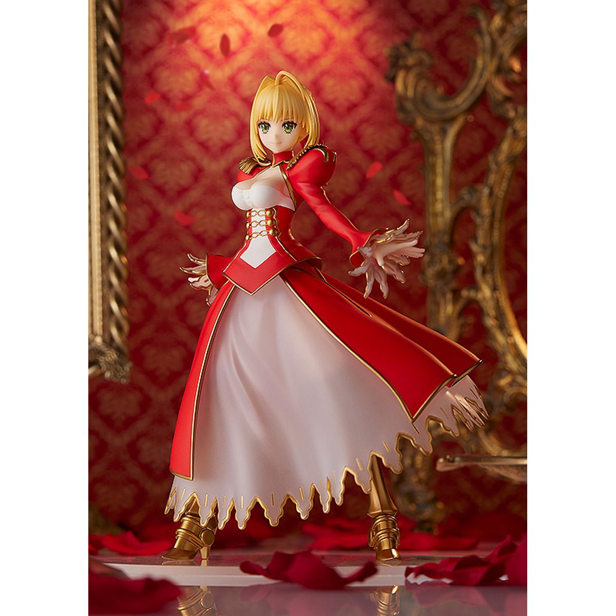 Nero Claudius Pop Up Parade figure in bright red dress, smiling confidently with arms raised.