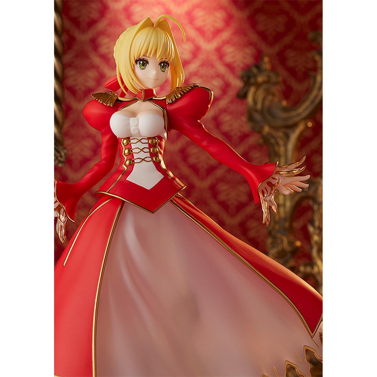 Nero Claudius Pop Up Parade figure in bright red dress, smiling confidently with arms raised.