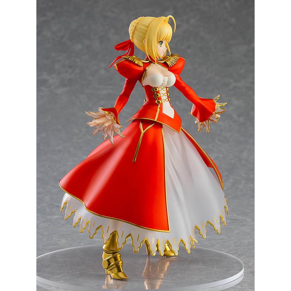Nero Claudius Pop Up Parade figure in bright red dress, smiling confidently with arms raised.