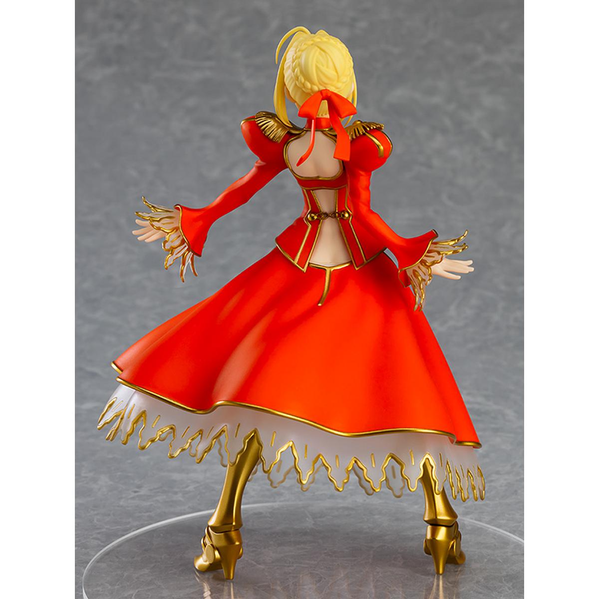 Nero Claudius Pop Up Parade figure in bright red dress, smiling confidently with arms raised.